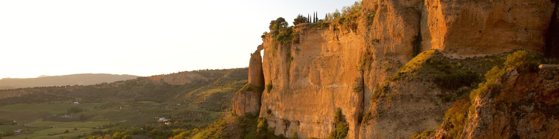 El Tajo Gorge featuring a gorge or canyon, a sunset and farmland