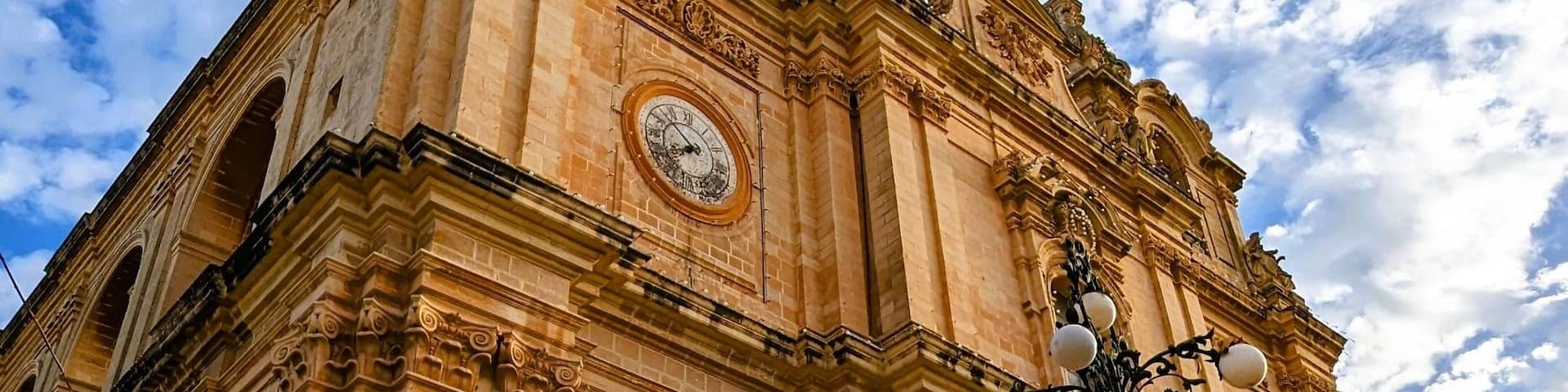 Imposing Facade of St. Helen's Basilica Under a Blue Sky, Malta