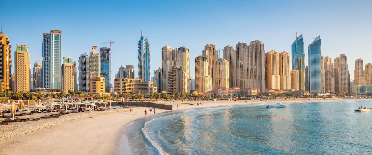 A beach with a city skyline in the background.
