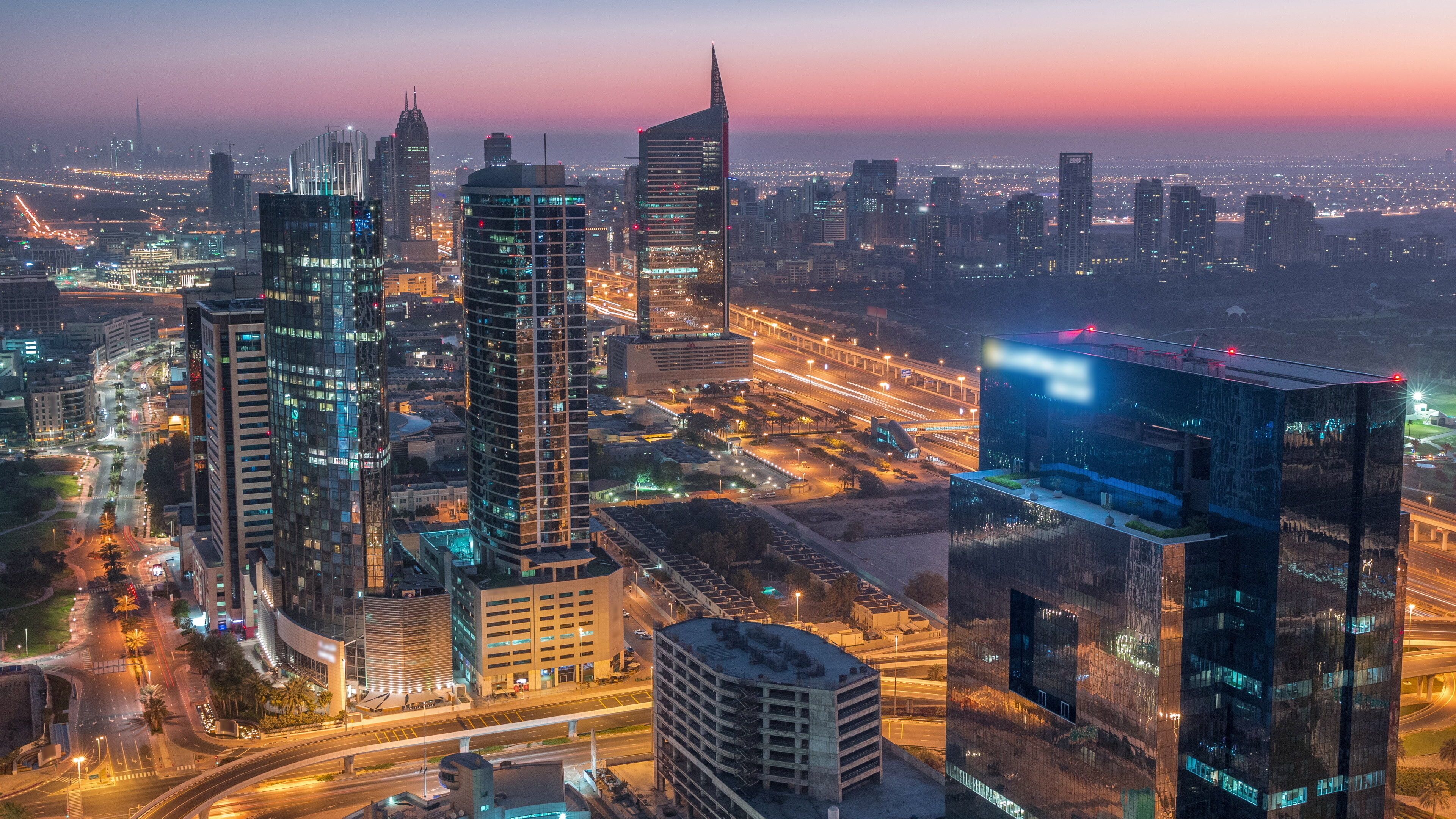 Aerial view of media city and al barsha heights district area night to day timelapse from Dubai marina.
