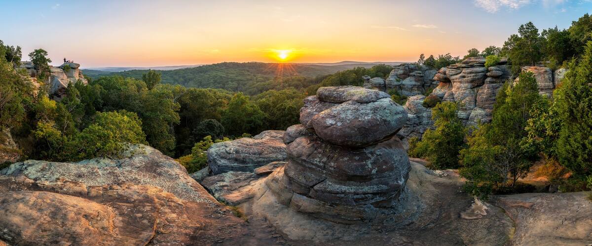 A rocky landscape with a sunset in the background.