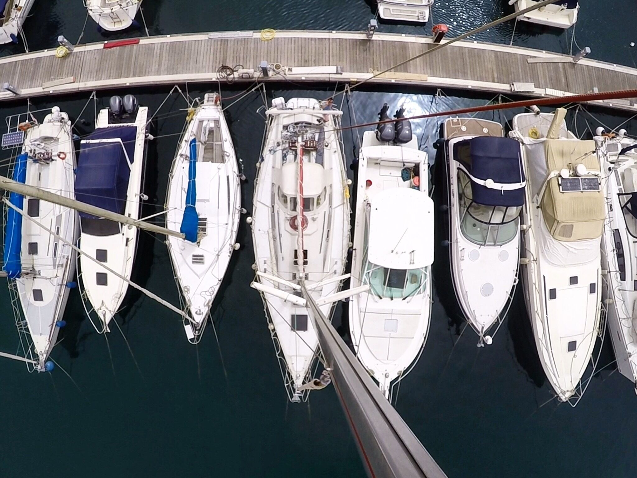 A marina with several boats docked in a row.