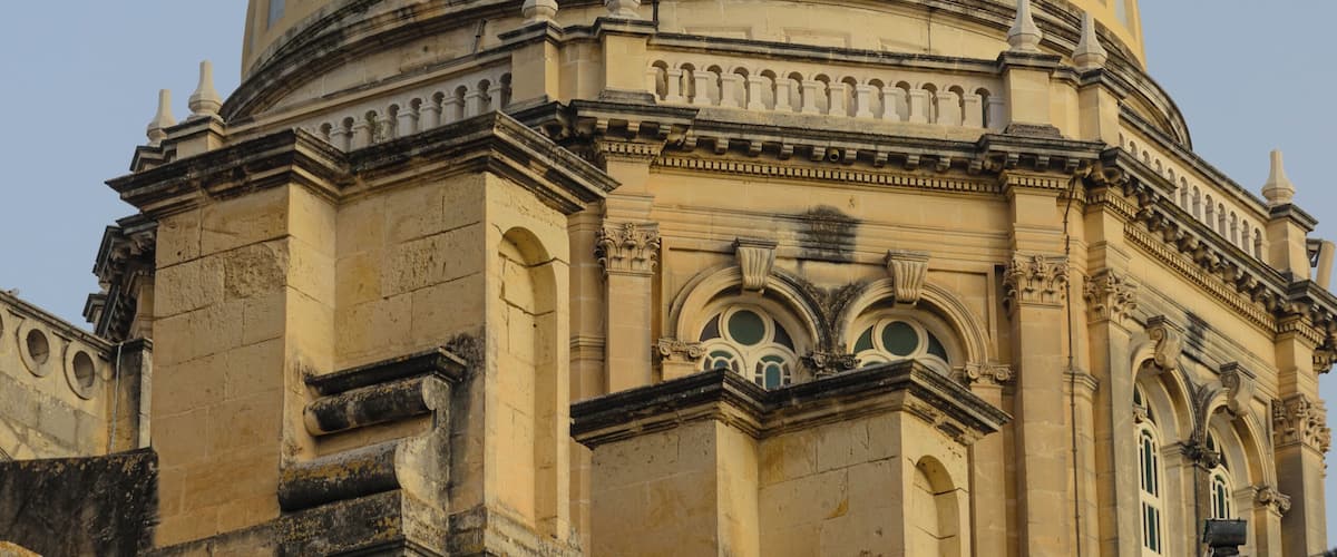 A large, ornate dome with a cross on top, part of a historic building.