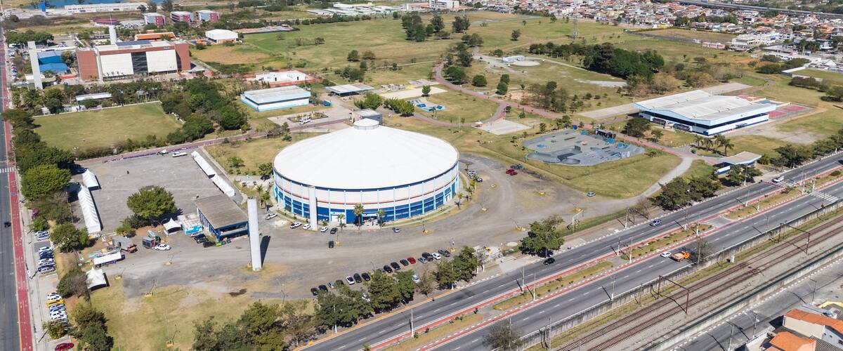 A large circular stadium surrounded by roads, buildings, and greenery.