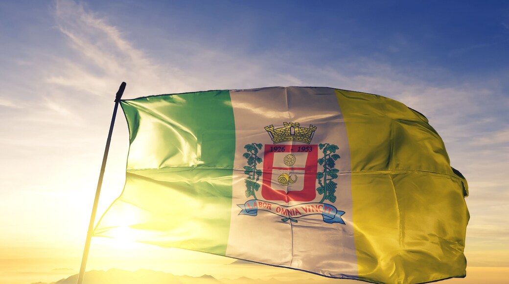 Ferraz de Vasconcelos of Brazil flag waving on the top sunrise mist fog