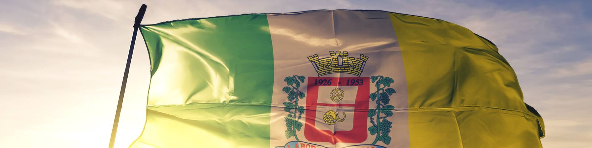 Ferraz de Vasconcelos of Brazil flag waving on the top sunrise mist fog