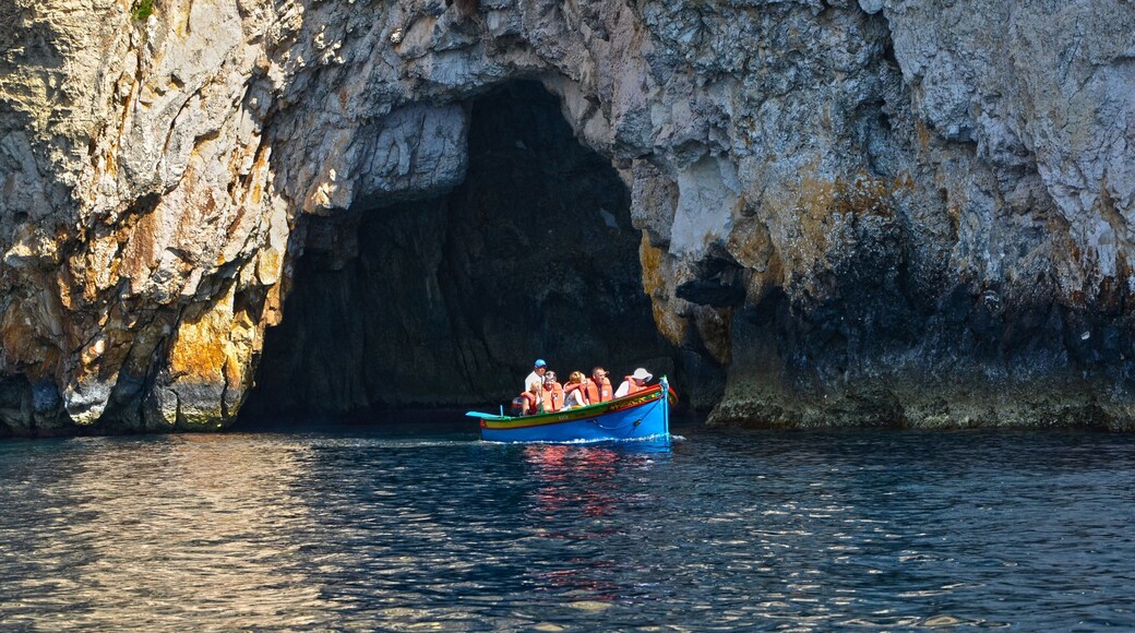 Zurrieq showing caves and boating as well as a small group of people