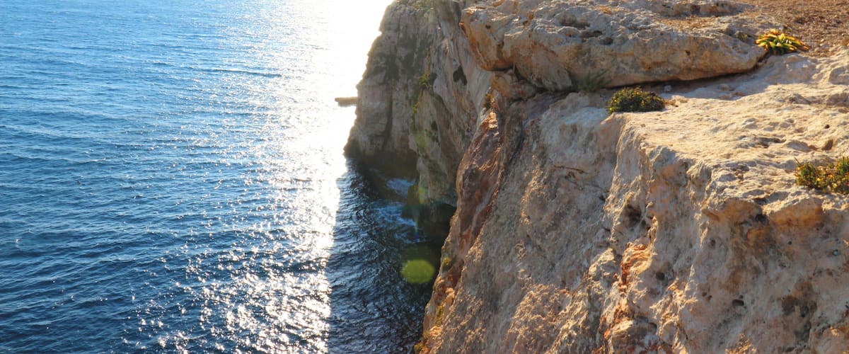 A rocky coastline with a clear view of the sea.