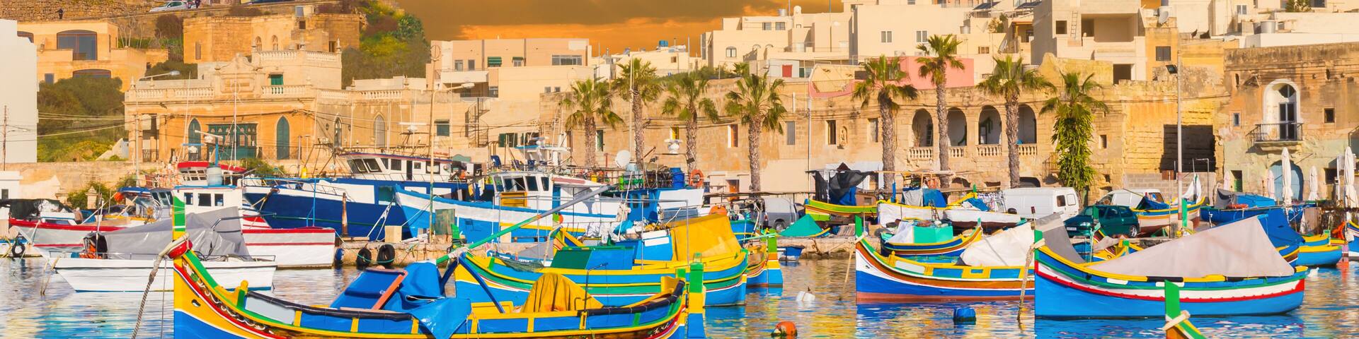 Marsaxlokk bay harbour of Malta, with beautiful architecture and boats at dusk