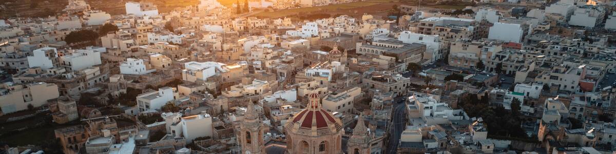 Aerial view of the historic parish church of Mellieha surrounded by charming rooftops at sunset, Ghaxaq, Malta.