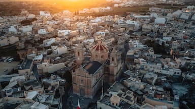 Aerial view of the historic parish church of Mellieha surrounded by charming rooftops at sunset, Ghaxaq, Malta.
