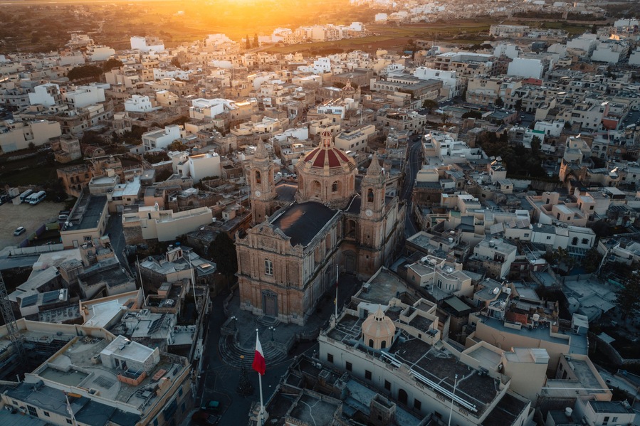 Aerial view of the historic parish church of Mellieha surrounded by charming rooftops at sunset, Ghaxaq, Malta.
