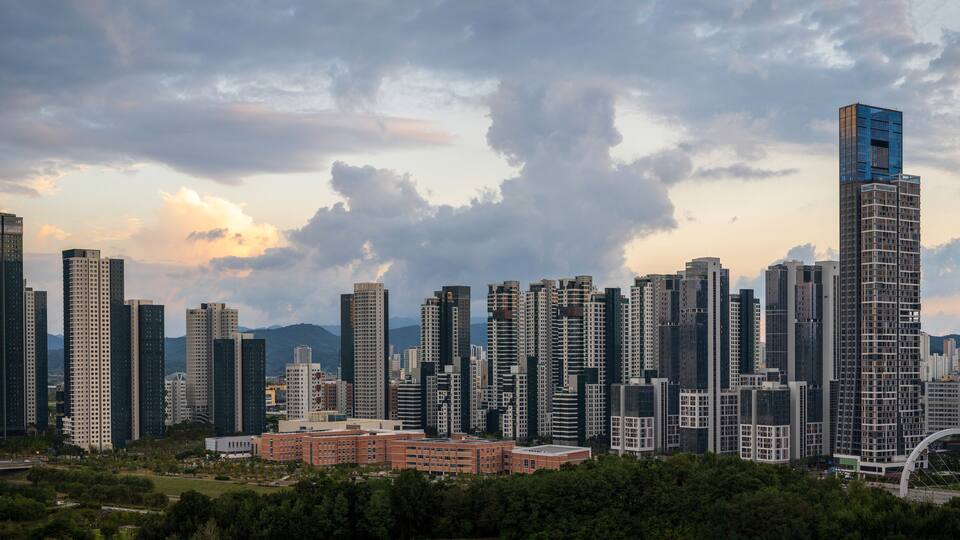 A cityscape with tall buildings and a bridge.