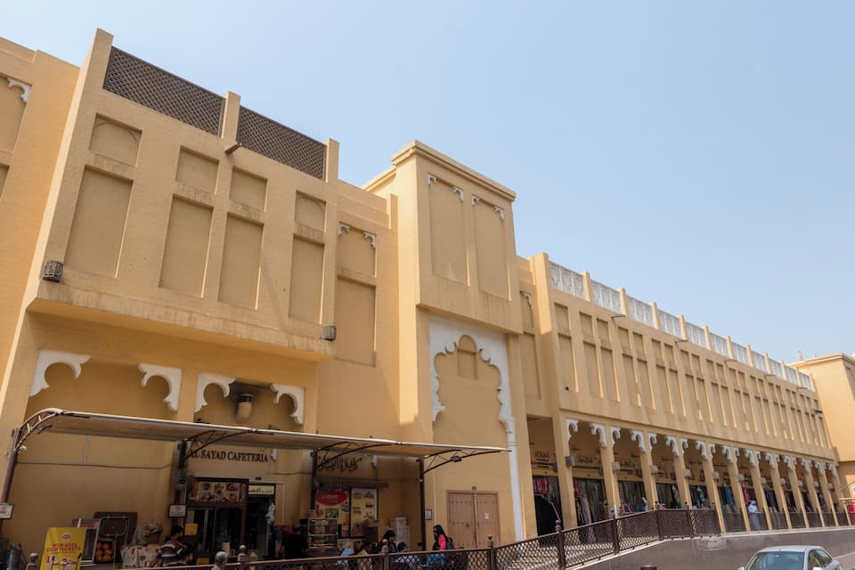 A traditional building with arched windows and a covered walkway.