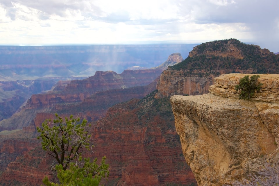 A canyon with layered rock formations and a prominent cliff edge.