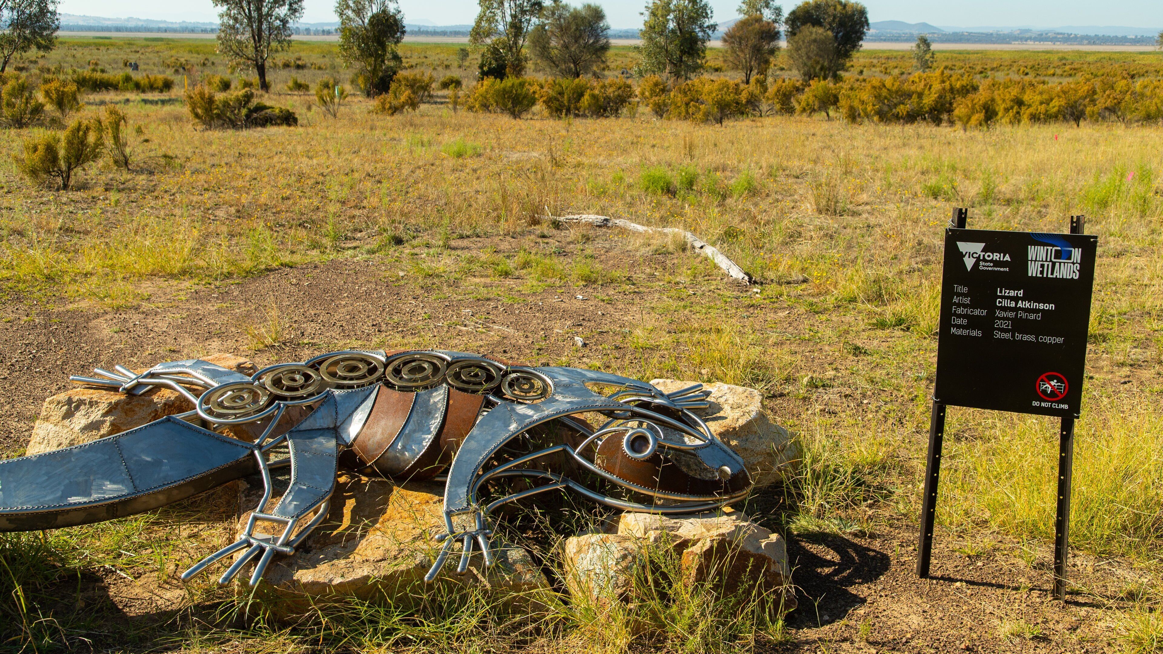 Winton Wetlands featuring signage, outdoor art and tranquil scenes
