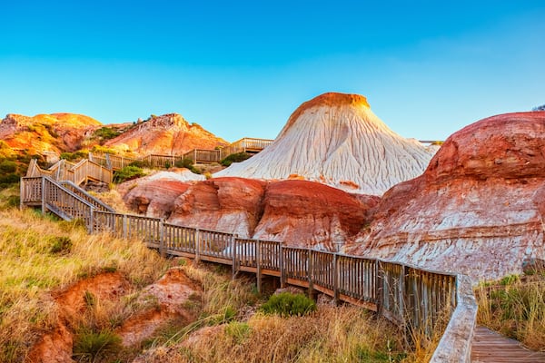 Walking trail with wooden stairs around the Hallett Cove Sugarloaf at sunset