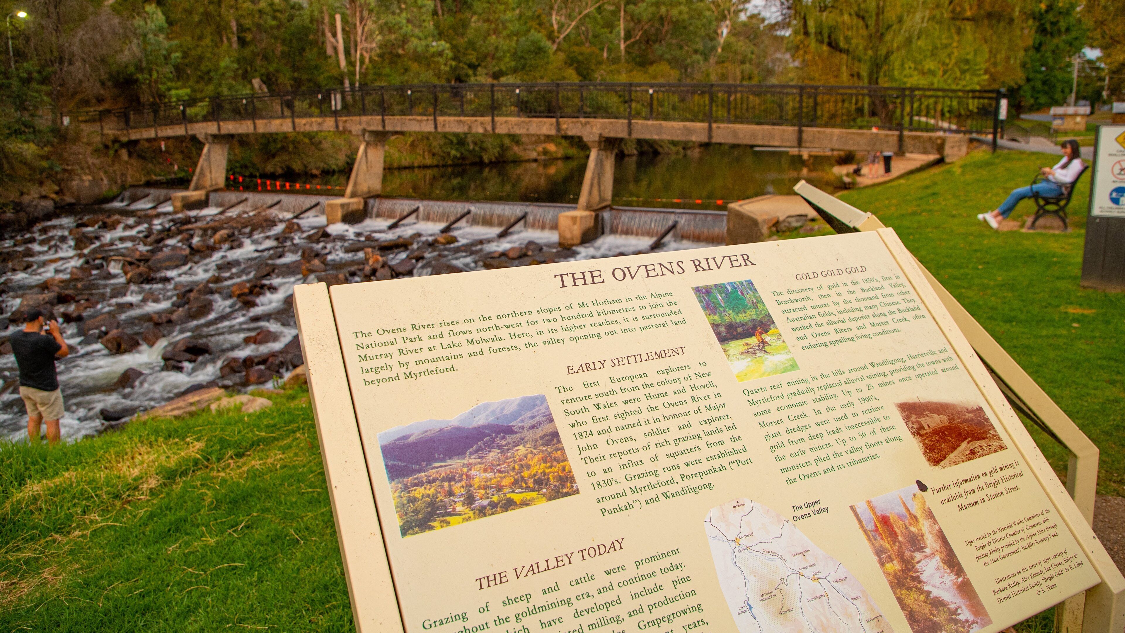 Centenary Park Streamside Reserve featuring a river or creek and signage