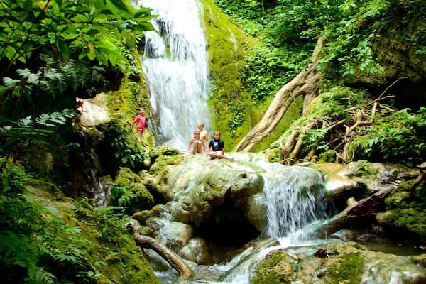 Mele Cascades featuring a cascade and rainforest as well as children