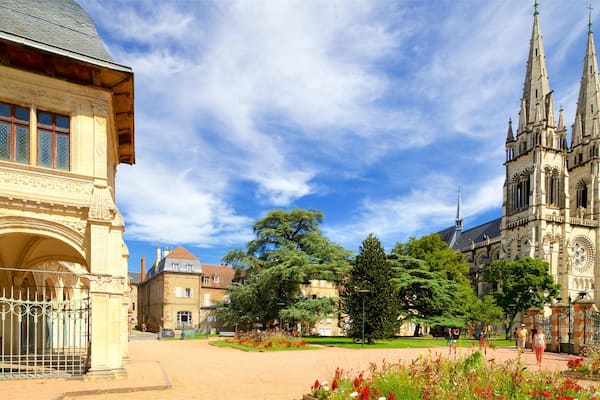 A historic building with ornate architecture and a large church with spires.
