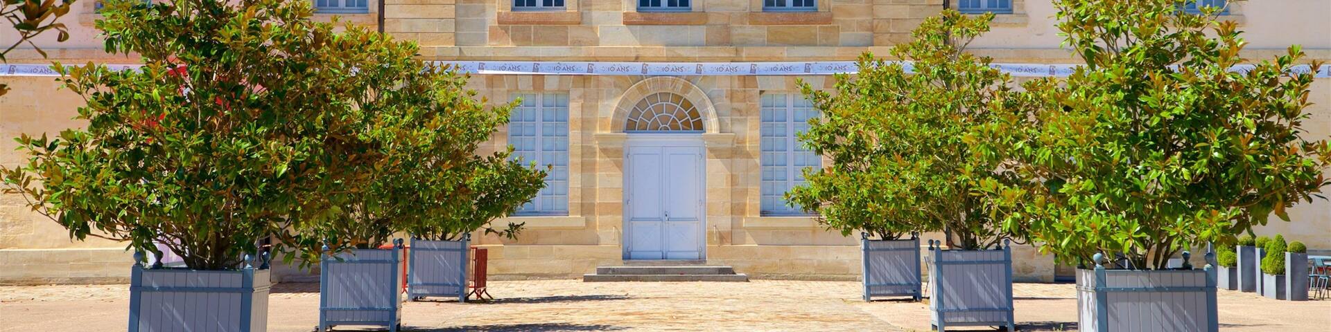 A historic building with a symmetrical facade, large windows, and a central entrance.