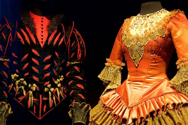 Two elaborate costumes with intricate designs and embellishments.
