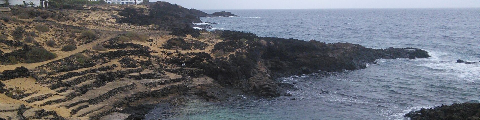 Charco del Palo, Lanzarote. Natural swimming pool, high tide.