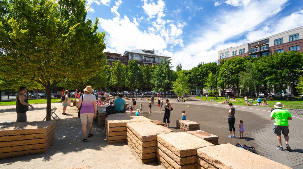 Jamison Square featuring a park as well as a small group of people