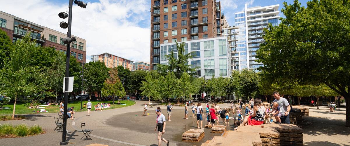 Jamison Square which includes a park as well as a small group of people