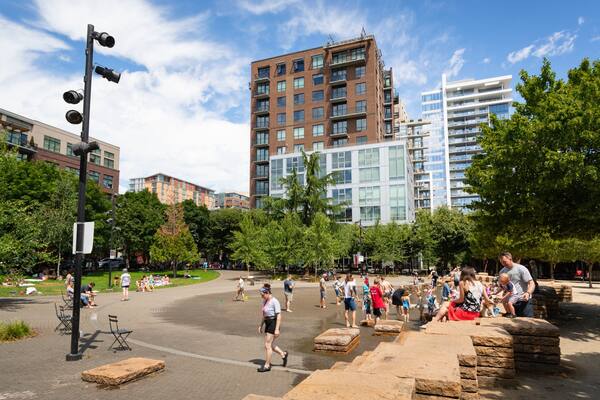 Jamison Square which includes a park as well as a small group of people