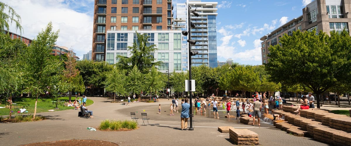 Jamison Square which includes a park as well as a small group of people