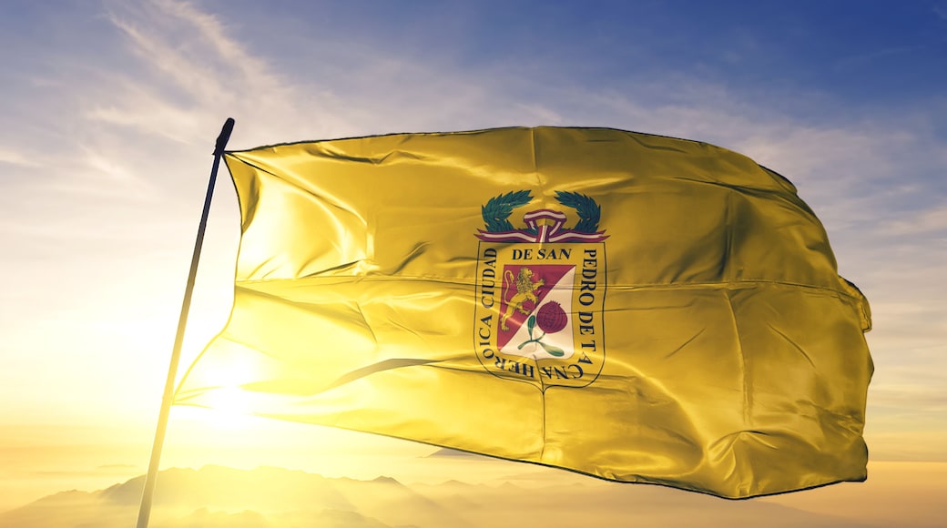 Tacna of Peru flag waving on the top sunrise mist fog