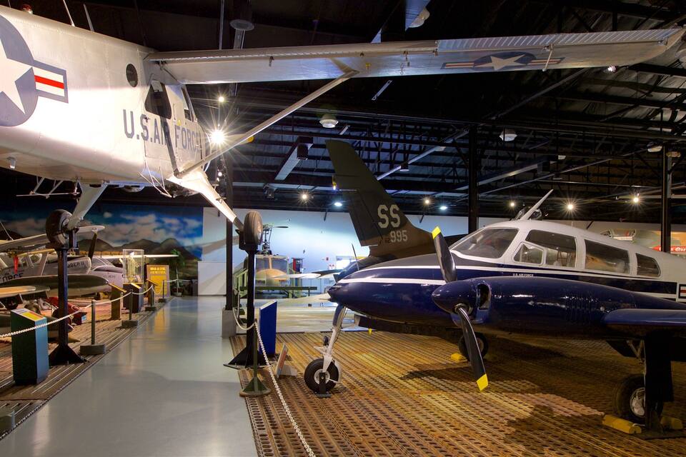 A museum exhibit with various military aircraft, including a U.S. Air Force plane with the tail number SS-62-995.