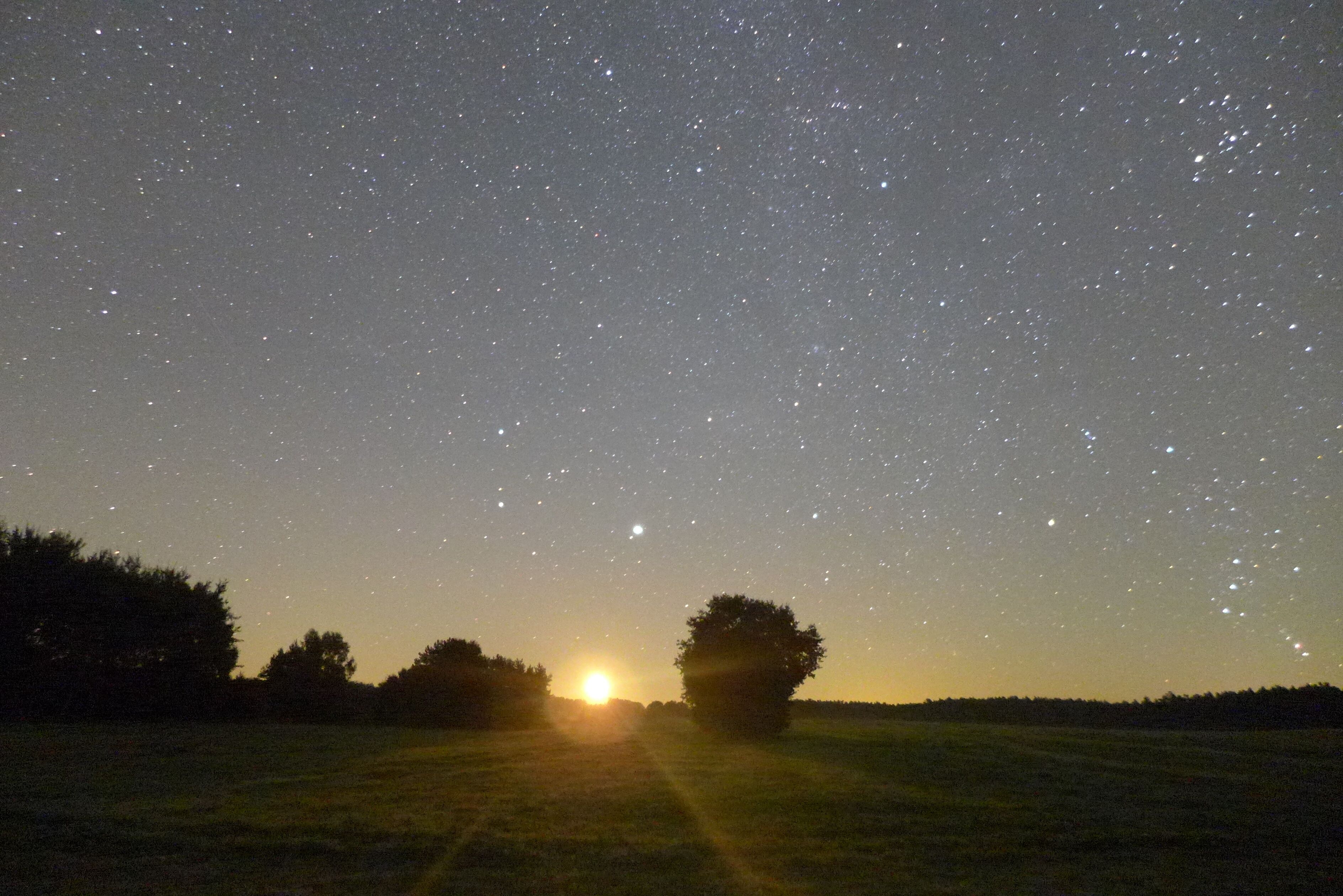 The moon is shown rising over a field adjacent to Müritz National Park. The bow of Orion is visible at the far right of the image, and Jupiter is just above the rising moon, in the constellation Gemini. A faint meteor is also visible at center left. The German state of Mecklenburg-Vorpommern is home to some of the most pristine night skies in Germany. The image was taken during a light pollution measurement campaign by Alejandro Sanchez de Miguel and Christopher Kyba. Sanchez de Miguel was in Berlin as part of a Short Term Scientific Mission of the EU COST Action LoNNe. More information about LoNNe is available here: http://www.cost-lonne.eu/ This photo was featured as part of the "View from your App" series on the "Loss of the Night" blog: http://lossofthenight.blogspot.de/search/label/view%20from%20your%20app An annotated version, with outlines showing the constellations is available here: https://twitter.com/skyglowberlin/status/465975616010190849/photo/1