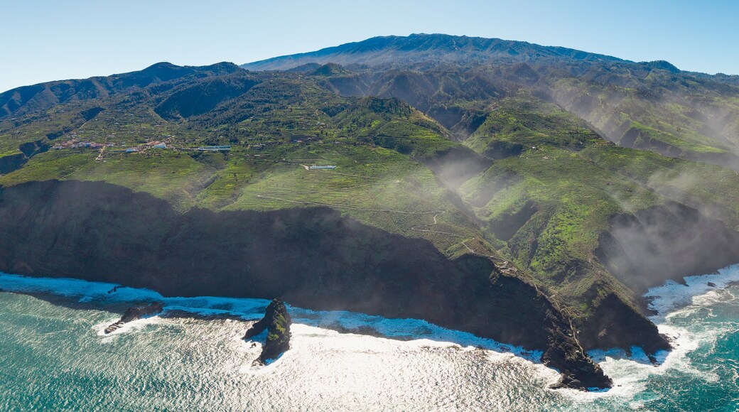 Aerial view of rugged coastline with waves crashing against cliffs and panoramic landscape, Garafia town, La Palma Island, Canary Islands, Spain.