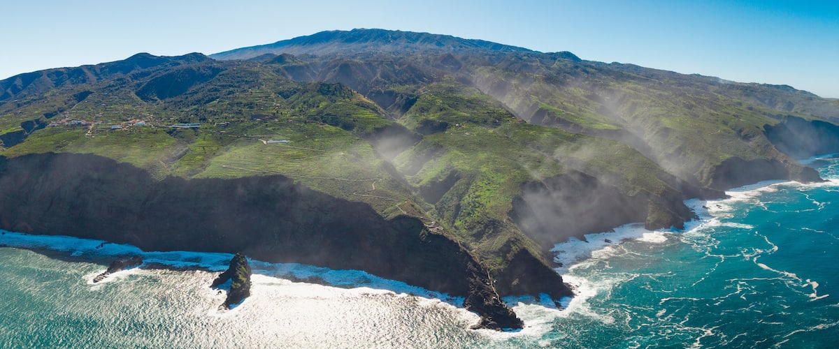 A coastal mountain range with steep cliffs and a rugged coastline.