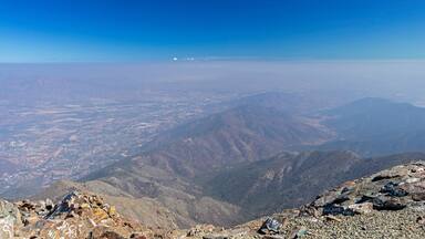 Mountain summit view with landscape of Andes and Aconcagua on clear day in La Campana National park in central Chile, South America