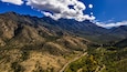 Aerial panorama of Madera Canyon in the Santa Rita Mountains, Arizona in the Fall with purple mountains, green, yellow, orange trees and bushes, blue sky