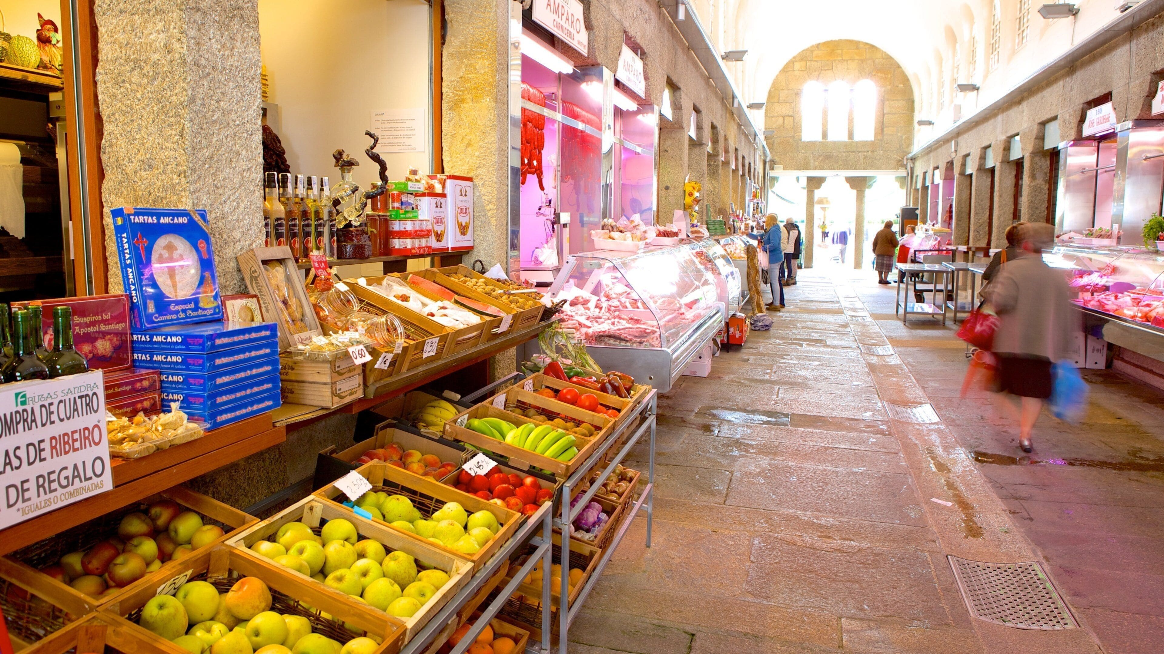 A market with various stalls selling fruits, bread, and other goods.