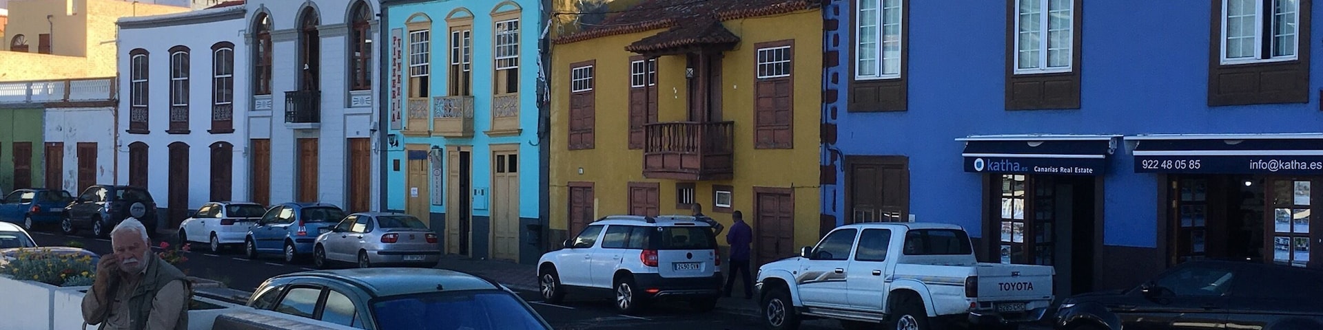 Main square, pretty colourful houses overlooking the banana plantations and the sea in the distance.