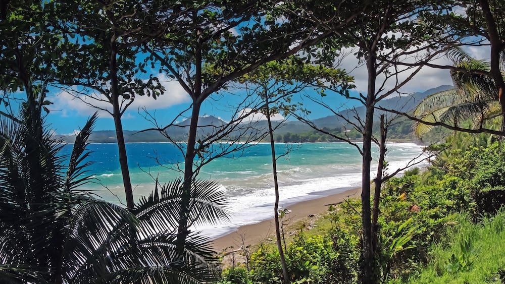 Beautiful tropical caribbean lonely lagoon, turquoise blue water, empty sand beach, strong surf waves - Port Antonio, Jamaica