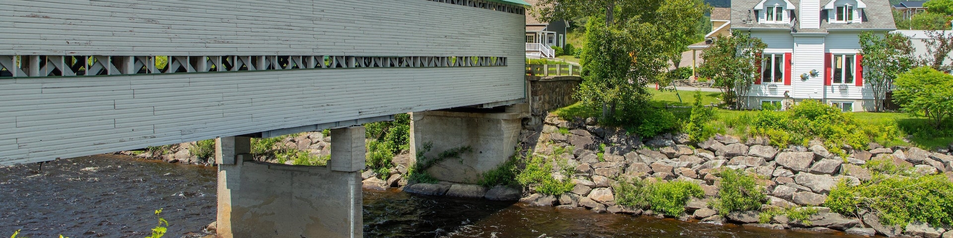L\'Anse-Saint-Jean which includes a bridge and a river or creek