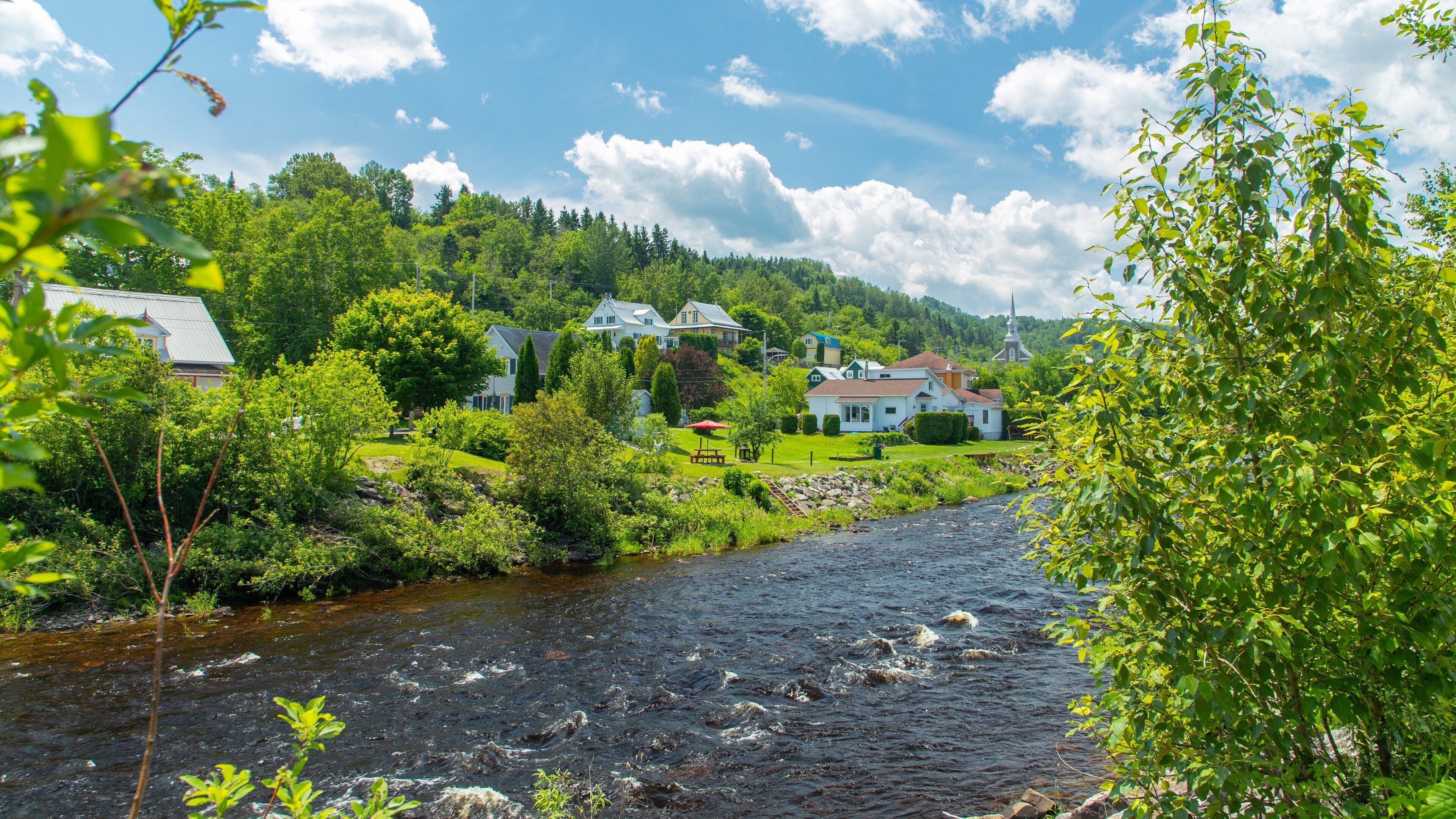 L\'Anse-Saint-Jean featuring a small town or village and a river or creek
