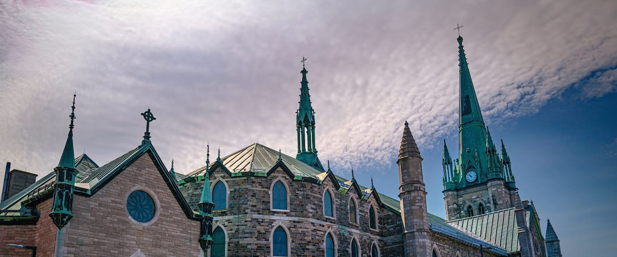 A historic church with multiple spires and a large clock tower.