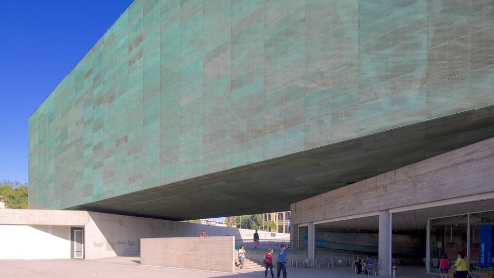A modern building with a large overhanging structure.