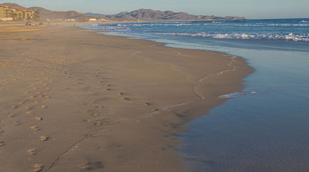A calm sunset on the beach with ocean waves and mountains in the background Todos Santos Baja California Sur. Mexico