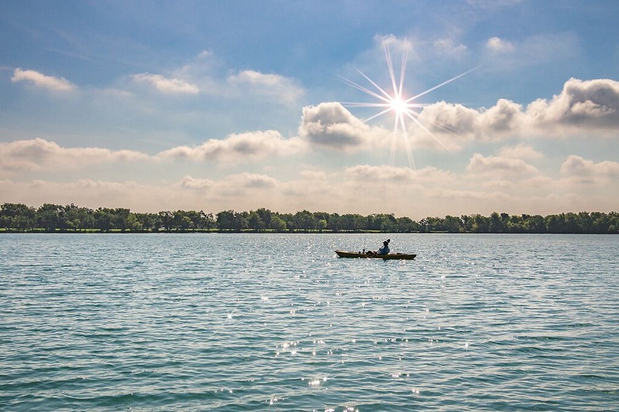 A lone kayaker enjoying a beautiful day on Lake Friendswood