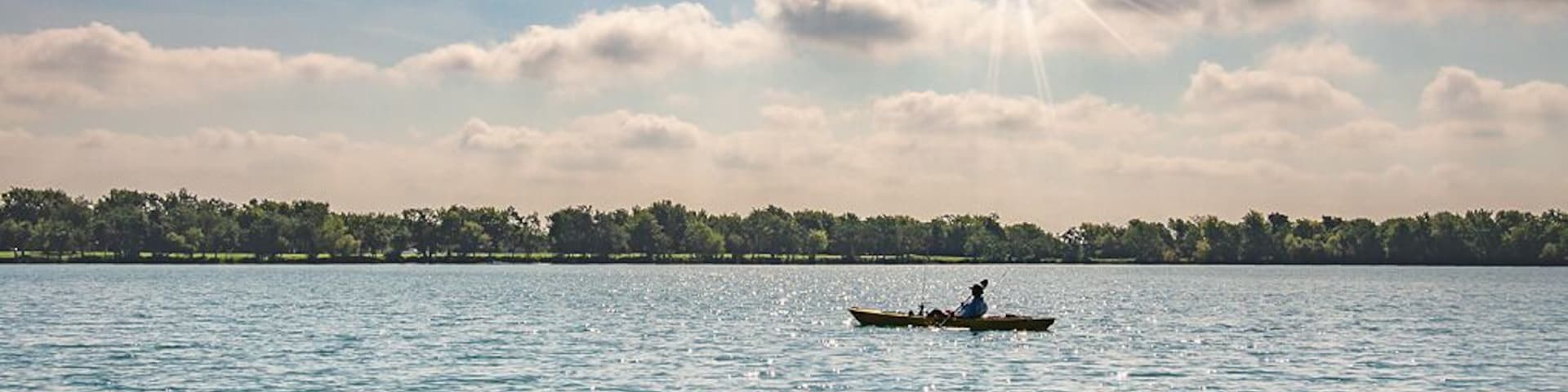 A lone kayaker enjoying a beautiful day on Lake Friendswood