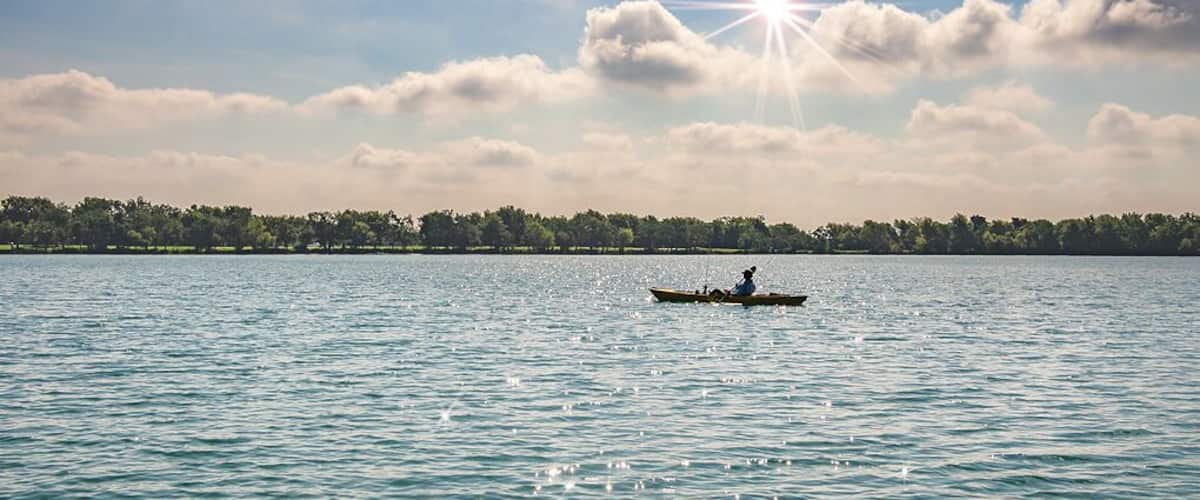 A lone kayaker enjoying a beautiful day on Lake Friendswood
