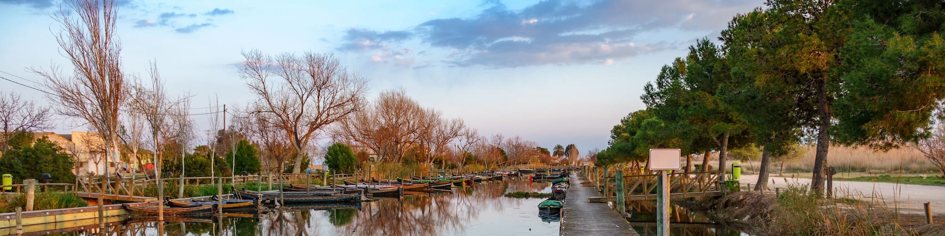 Albufera nature reserve with wooden fishing boats and pier in Catarroja